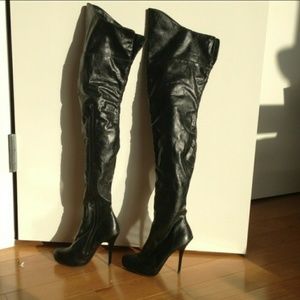 Black mid-thigh, over the knee leather boots.
